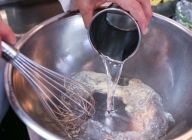 【衣】ボウルにイーストを入れ、水を注いでしっかり溶かした後、塩・強力粉・薄力粉を入れる。ダマがなくなるまで全体を混ぜる。